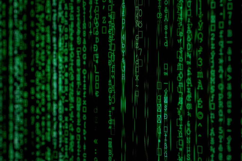 pexels-photo-1089438-1089438 Abstract green matrix code background with binary style.