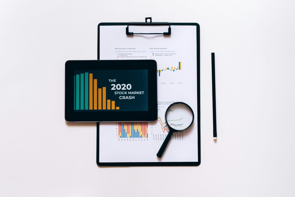 pexels-photo-5561919-5561919 Tablet, magnifying glass, and clipboard for stock market analysis.